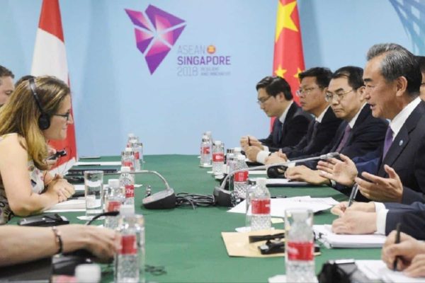 China's Foreign Minister Wang Yi, second right, and Canada's Foreign Minister Chrystia Freeland, first left, at a bilateral meeting on the sidelines of the 51st ASEAN Foreign Ministers Meeting in Singapore, Friday, Aug. 3, 2018. (AP Photo/Joseph Nair)