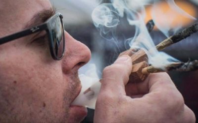 Brandon Bartelds smokes three joints at once while attending the 4-20 annual marijuana celebration, in Vancouver, B.C., on Friday April 20, 2018. THE CANADIAN PRESS/Darryl Dyck